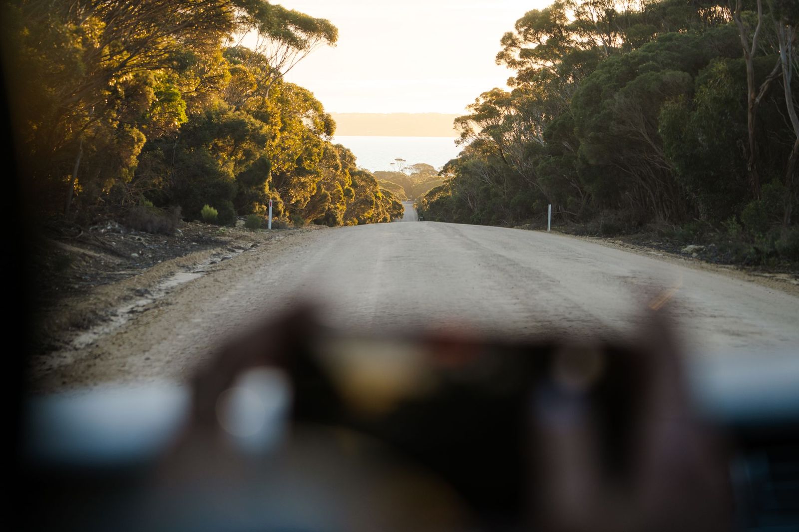 Dirt road leading down to the ocean at Island Beach, Kangaroo Island