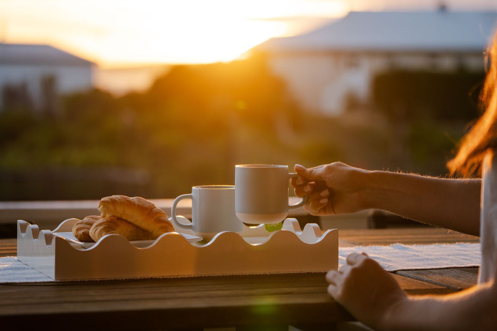 Coffee and croissants on the deck at sunset