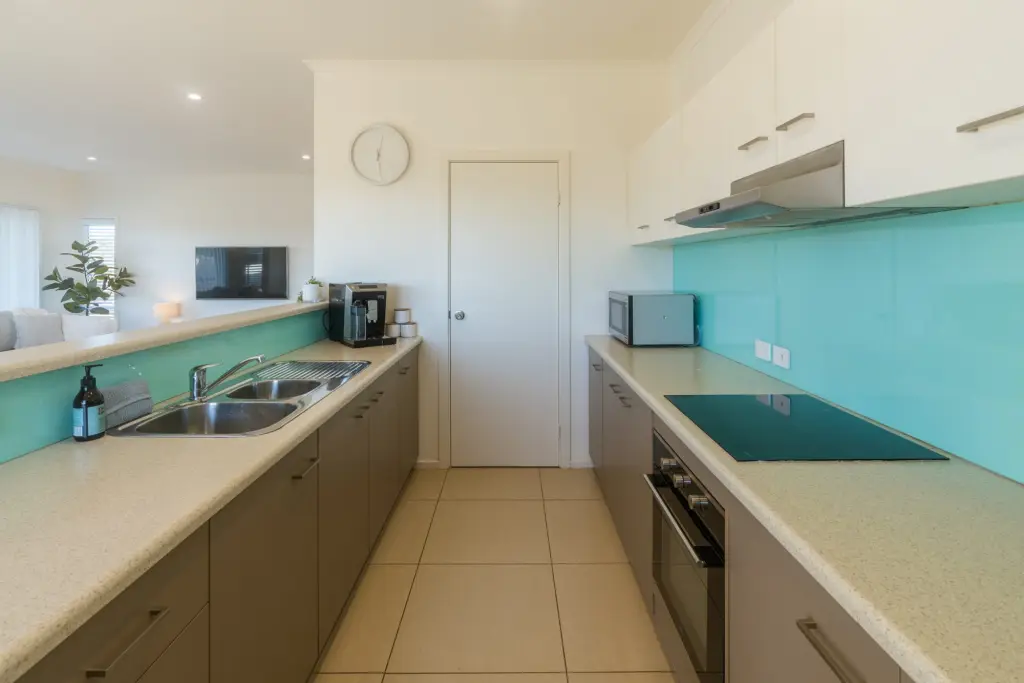 Fully equipped galley kitchen with coffee maker and dining bar