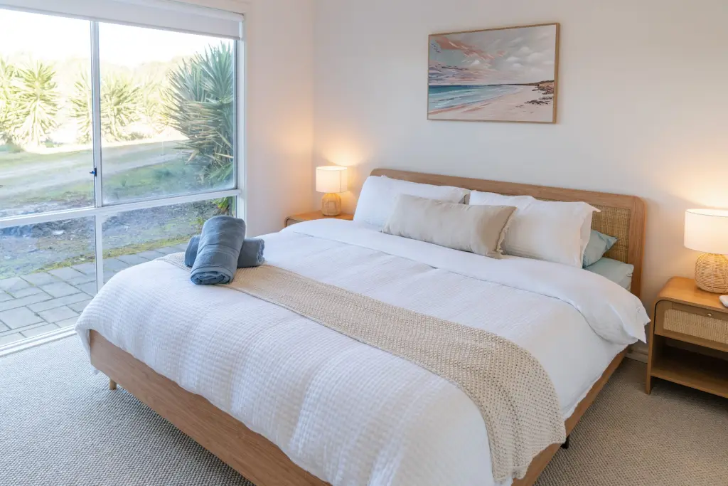 Guest bedroom with queen bed and soft natural light