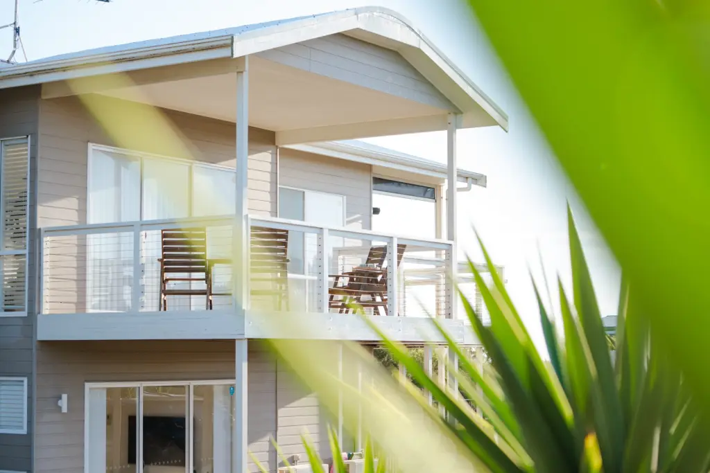 The house framed by coastal greenery